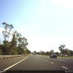 Car driving onto freeway entrance ramp