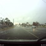 Car driving in heavy rain in traffic